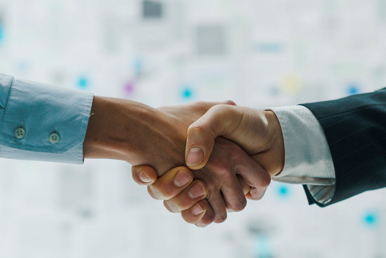Corporate business partners meeting and shaking hands, agreements and contracts concept